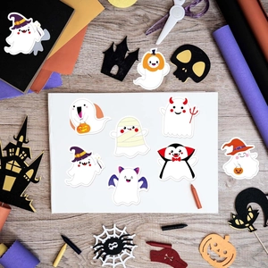 Macro view of assorted cartoon ghost stickers with pumpkins and witch hats for Halloween