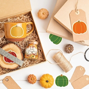 Close-up of Hello Pumpkin stickers with gold glitter edges on gift boxes and crafts