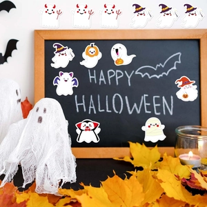Close-up of cute Halloween ghost stickers with pumpkins and wizard hats on dark background