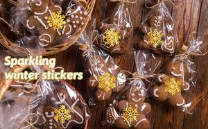 Golden snowflake stickers on a gift bag with gingerbread cookies for holiday decor