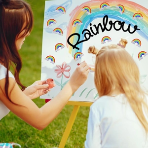 Macro view of rainbow laser decorative stickers with white clouds on a drawing board