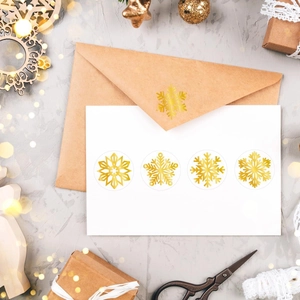 500 Gold foil snowflake stickers on a roll for Christmas envelopes and holiday gift wrap