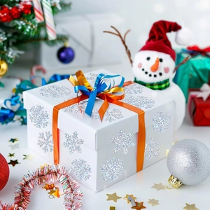 Détail de stickers flocons holographiques argentés sur boîte cadeau avec décor de Noël