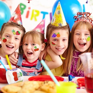 Kids at birthday party wearing colorful glitter fruit stickers from a large 500pcs roll
