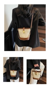 Detail of vintage canvas and leather bucket bag with gold lock and thin shoulder strap