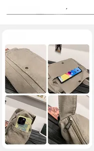 Detail view of khaki canvas messenger bag featuring front pocket and durable metal zipper