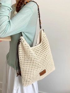 Chic beige crochet tote bag with wooden bead straps and inner lining for beach vacations