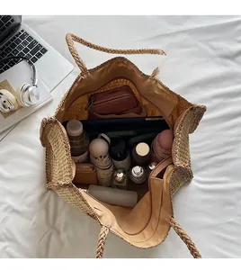 Top view of large straw tote bag interior showing ample storage space and zippered pocket