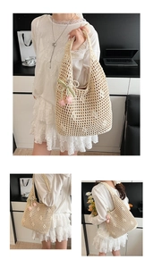 Detail of beige crochet tote bag featuring hollow mesh pattern and tulip charm