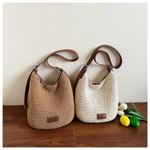 Detail showing handwoven hobo bags in tan and beige with brown faux leather straps