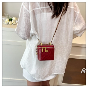 Red embossed snake texture crossbody bag with gold flower detail and chain strap