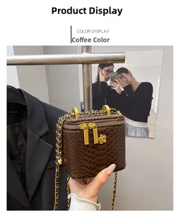 Detail of coffee brown square mini bag featuring faux crocodile texture and gold flower charm