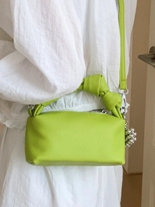 Lime green pleated cloud bag with knot handle and silver bead pendant for women