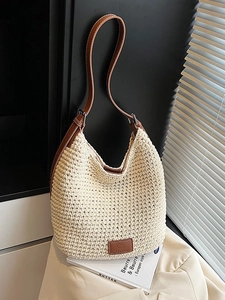 Woven large capacity bucket bag with brown leather straps and beige knit texture