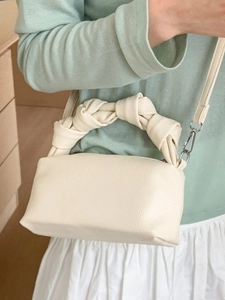Chic beige knotted cloud bag with lychee grain texture and detachable shoulder strap