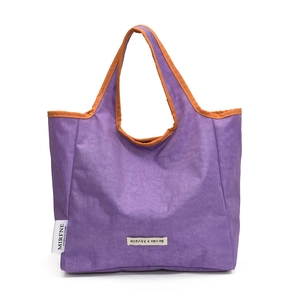 Stylish purple canvas tote bag with orange trim, perfect for casual daily shopping.