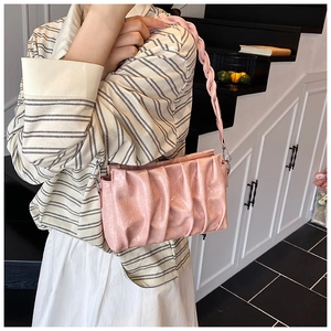Sac à bandoulière plissé rose avec bandoulière tressée chic vue de côté sur mannequin