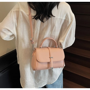 Pink lychee grain faux leather crossbody bag with adjustable strap and silver metal buckle