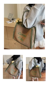Detail view of woven straw tote bag with green handles and Summer Vibes embroidery