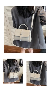 Detail view of beige lychee texture leather crossbody bag with silver metal hardware