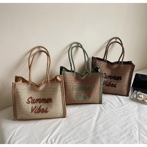 Three straw tote bags in beige green and brown colors featuring Summer Vibes embroidery