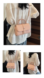 Close-up of pink litchi grain leather bag with silver metal trim and adjustable strap