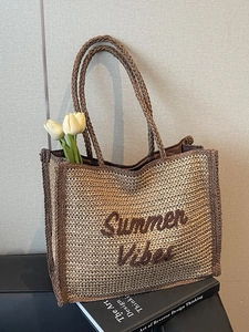 Chic woven straw underarm bag with Summer Vibes embroidery and brown handles