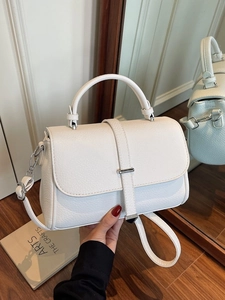 Elegant white lychee leather crossbody bag with silver hardware and chic flap closure