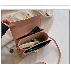 Pink faux leather handbag interior showcasing multiple compartments and storage capacity