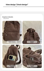Detail view of brown canvas backpack with reinforced handle, side pockets, and smooth zippers