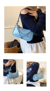 Light blue hobo bag with silver chains and heart charm worn by a model in a cozy setting