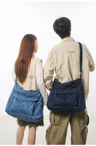 Detail view of large denim tote bags in dark and light blue with adjustable straps