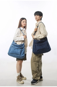 Dual view of large denim tote bags in light and dark blue shown on models