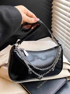 Glossy black patent leather shoulder bag with silver chains and heart charms