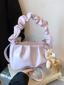Chic lavender pleated handbag with cute bear charm and adjustable shoulder strap