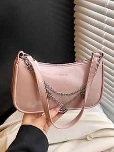 Chic pink patent leather half-moon shoulder bag with silver chain and heart charm