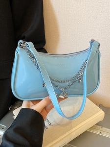 Light blue glossy patent leather baguette bag with silver chain and heart charm detail