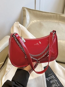 Red glossy patent leather shoulder bag with silver chain and heart pendant for women