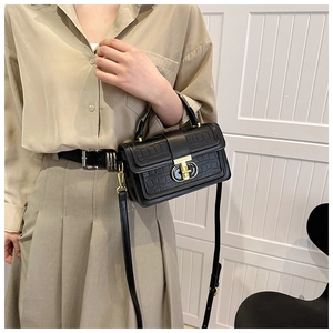 Detail of vintage crocodile pattern leather bag with gold buckle on crossbody strap