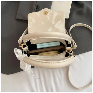 Internal view of cream leather handbag showing zipper pocket and spacious capacity