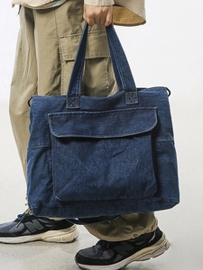 Large dark blue denim tote bag with vintage wash and utility front pocket for daily use
