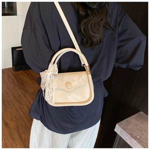 Creamy white structured mini bag with lace bow detail and detachable shoulder strap