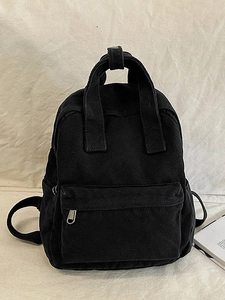 Minimalist black canvas backpack for women with top handle and adjustable straps