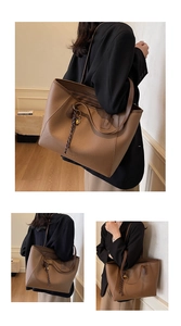 Detailed close-up of brown litchi pattern tote bag with braided rope and gold lock charm
