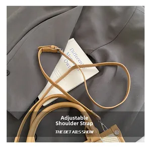 Detail of adjustable khaki PU leather shoulder strap with silver metal buckle on tote bag