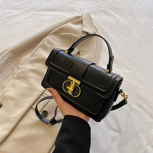 Elegant black crocodile texture handbag with gold T-clasp and top handle