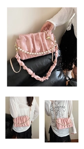 Détails du sac plissé rose avec poignée en perles et finition en cuir brillant
