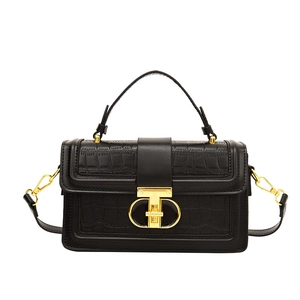 Elegant black crocodile embossed handbag with gold T-bar lock and structured top handle