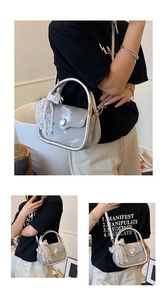 Chic silver crossbody bag with metallic round handle and delicate white lace bow detail