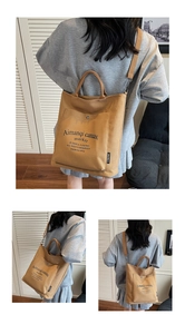 Detail of camel canvas tote featuring adjustable straps and functional exterior pocket